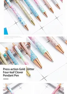 Metal ballpoint pen featuring sparkling glitter, mermaid scales, and clover pendant details.