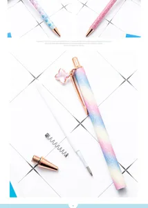 Metal ballpoint pen detail with glitter gradient body, clover crystal charm and refill.