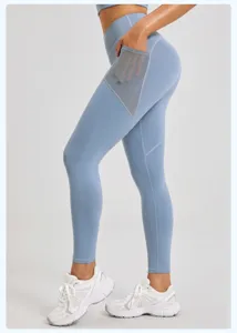 Detail view of high waist yoga leggings with mesh side pocket, stretch gym sports activewear pants.