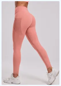 High-waisted pink yoga leggings with mesh side pockets, stretchy activewear for workout.