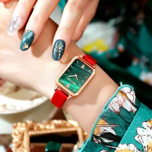 Charming close-up detail of retro green malachite dial rectangular ladies watch red leather strap.