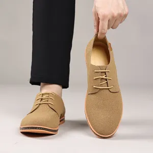 Men's casual suede leather shoes detail view, classic lace-up low-top design in light brown.
