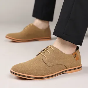 Men's brown suede casual dress shoes detail, featuring classic lace-up design and stitching.