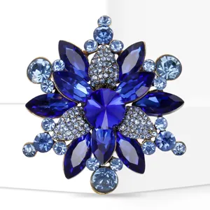 Close up view of the elegant blue crystal rhinestone flower brooch with alloy detail.