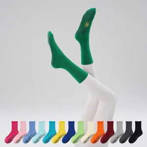 Green non-slip yoga socks for women, grip socks for pilates and fitness workouts detail.