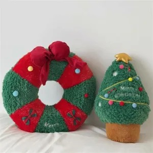 Detailed view of cute Christmas plush wreath and tree pillows, soft holiday home decor items.