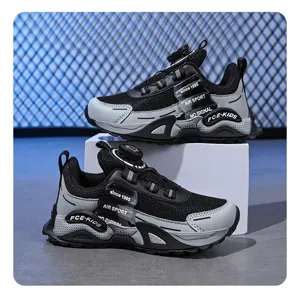 Kids athletic sneakers detail view, black and grey mesh running shoes with rotary dial lacing system.