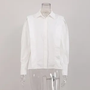 Chic white long sleeve shirt with structured shoulders for women, stylish French commuting top.