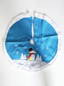 Blue Christmas tree skirt with plush white border and embroidered snowman and snowflake holiday decor.
