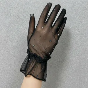 Exquisite black sheer mesh gloves detail featuring sparkling rhinestones and lace cuffs.