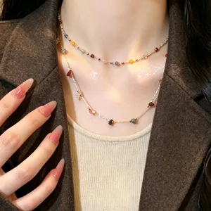 Delicate layered necklace featuring colorful natural stone charms on a dainty gold-tone chain.