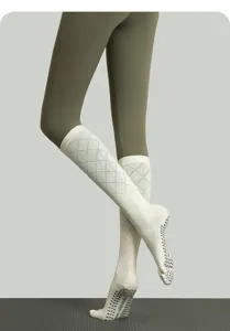 Detailed view of long non-slip pilates socks with diamond knit pattern and split toe design.