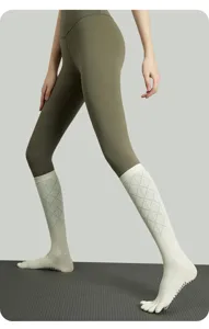 Detailed view of long yoga socks with five toes and anti-slip grips, breathable for pilates.