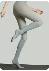 Grey long yoga socks for women, pilates toe socks with non-slip grip, breathable calf socks.