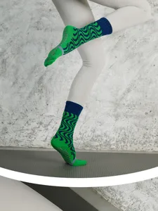 Detail view of cotton non-slip five-toe yoga socks with green and blue wave pattern.