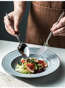 Close-up detail of vintage style stainless steel spoon and fork cutlery set used in dining.