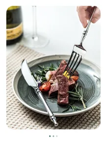 Elegant stainless steel western cutlery set with vintage handle design for dining table.
