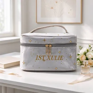 Detailed view of the portable velvet cosmetic bag with gold star prints and custom embroidery.