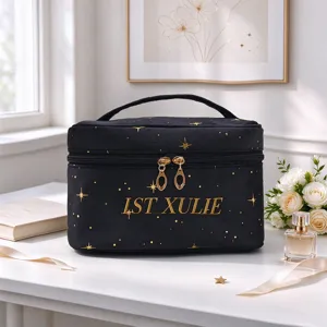 Black velvet cosmetic bag detail showing gold foil star pattern and custom lettering text.