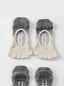 Detail view of non-slip yoga toe socks with open instep and silicone grip soles for workout.
