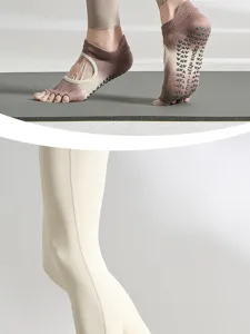 Detailed view of women's five-toe non-slip yoga socks with grip dots for fitness.