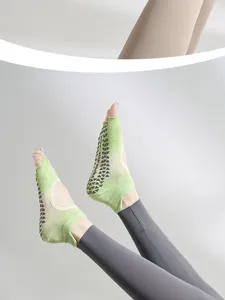 Non-slip yoga socks for women, toe-less five-toe design with grip dots for fitness pilates.