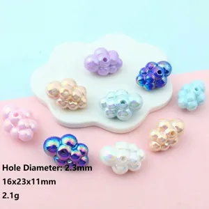 Detailed view of colorful iridescent acrylic cloud shaped hole beads for DIY jewelry crafting.