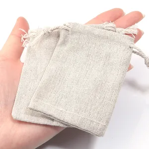 Small natural linen drawstring pouch detail shot, perfect for jewelry storage and gift wrapping.