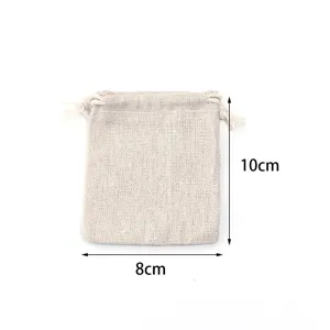Close-up detail of small beige linen burlap drawstring pouch, natural texture and rope close view.