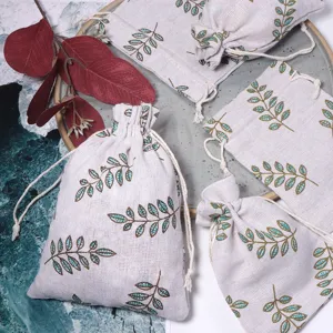 Linen drawstring pouches featuring green leaf prints, perfect for herb storage and small gifts.