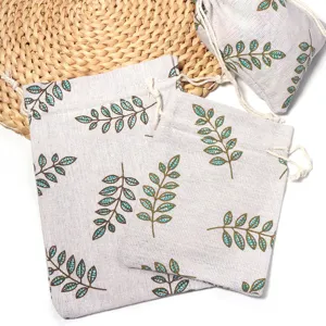 Natural linen drawstring pouch with green leaf print, perfect eco-friendly storage bag.