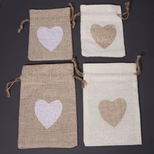 Detail view of small linen drawstring bags featuring charming heart prints, perfect for gifts.