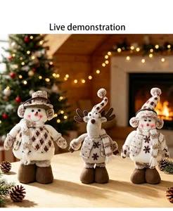 Detailed view of Christmas plush snowman and reindeer tabletop decoration with cozy background.