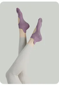 Detail shot of purple yoga grip socks with anti-slip dots, ideal for pilates and indoor fitness.