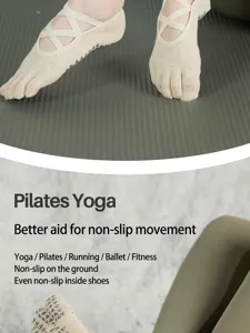 Women non-slip five toe yoga socks with cross straps for pilates gym fitness exercise.