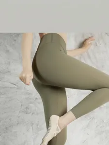 Women's high waist yoga leggings and professional non-slip pilates socks detail view.