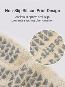 Close-up detail of anti-slip yoga socks featuring grey triangular silicone grips for stability.