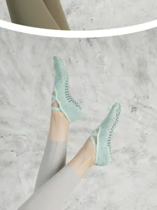 Non-slip grip pilates socks for women, strap design for indoor yoga fitness sports workout.