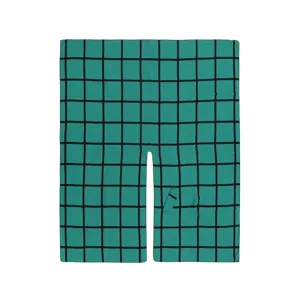 Detail view of the green plaid side-strap split cape shawl, featuring cozy warm grid fabric.