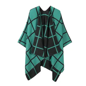 Detail view of the stylish green and black plaid open-front cape showing soft texture.