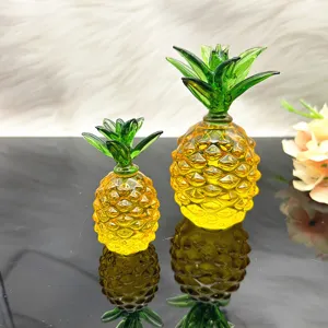 Primo piano sui dettagli dell'ornamento di ananas in cristallo, con vetro giallo e foglie verdi.