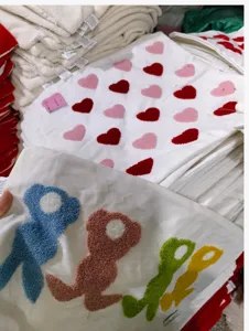 Detailed view of tufted heart and cute bear pattern canvas cushion cover, soft textured fabric.
