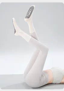 Detail view of non-slip yoga socks featuring grip dots on sole, mid-tube design for fitness.
