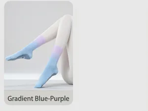 Detail view of gradient blue-purple non-slip yoga socks with black grip dots on soles.