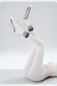 Detail view of women anti-slip yoga socks with gradient cuffs and grip dots for fitness pilates.