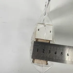 Wooden Christmas house ornament detail view with measuring ruler for holiday decoration.