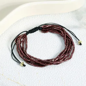 Exquisite multi-layer dark red tubular glass bead bracelet with black adjustable cord.