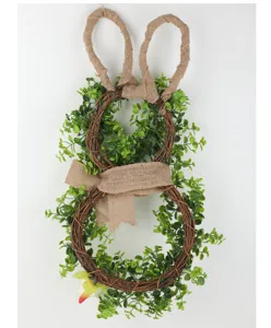Easter bunny wreath detail, handmade vine frame with green leaves and rustic burlap ribbon.