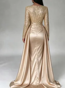Stunning gold long sleeve evening gown detail, sequin bodice and flowing satin skirt.