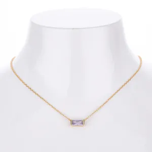 Close-up detail of the elegant purple zircon rectangular pendant on a fine gold chain necklace.